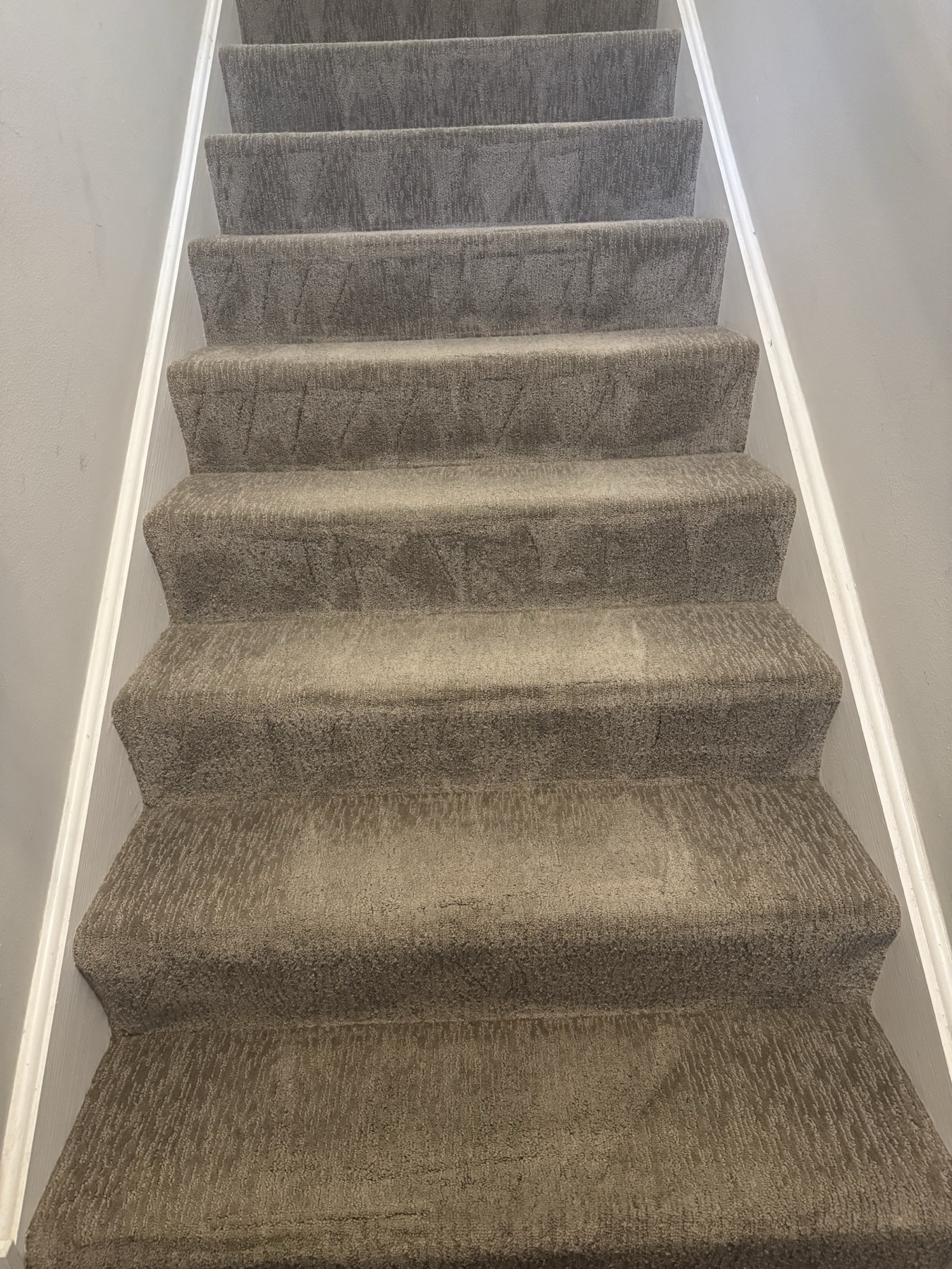 After: Gray carpeted stairs with traffic soil across the treads and risers, then the same staircase after cleaning