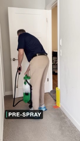 Kevin applying pre-spray to carpet